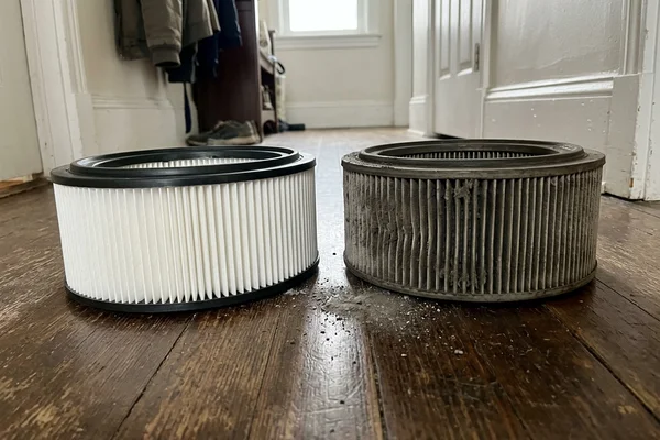 A clean pleated filter beside a heavily clogged one