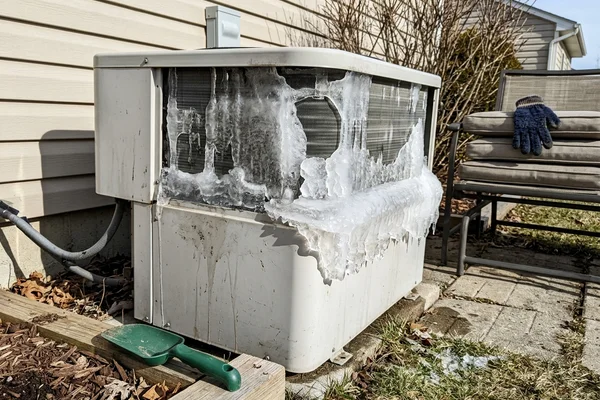 A heat pump outdoor coil encased in ice after a failed defrost cycle