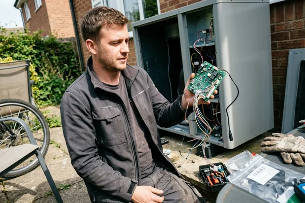 A defrost control board removed from a heat pump for testing