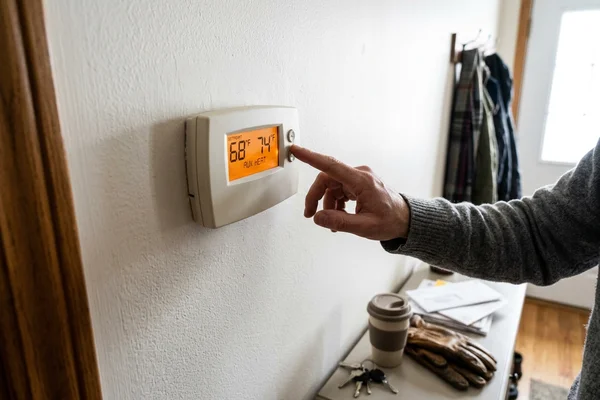 Thermostat showing the auxiliary heat indicator during a cold snap