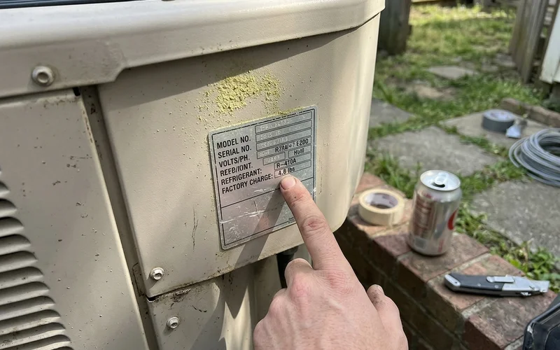 Data plate on a new condenser showing the refrigerant type and charge