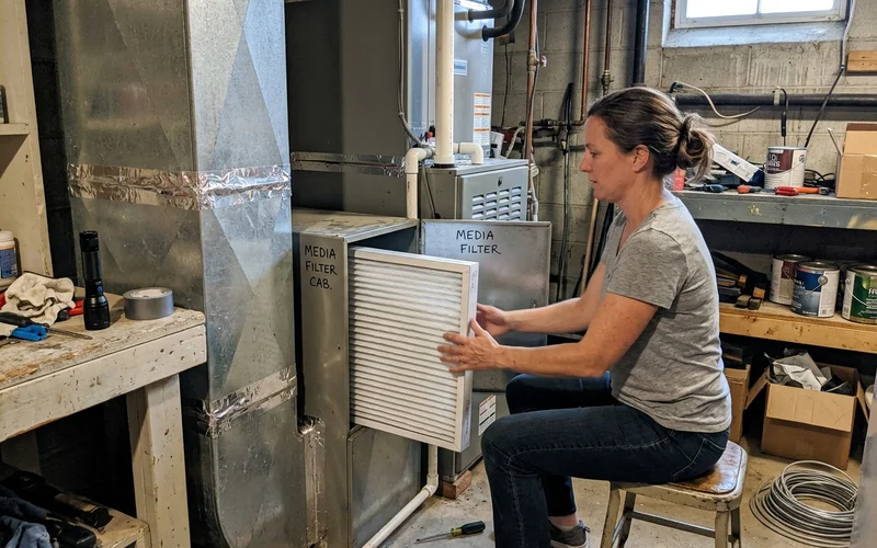 Whole-home air purifier installed in ductwork near an air handler