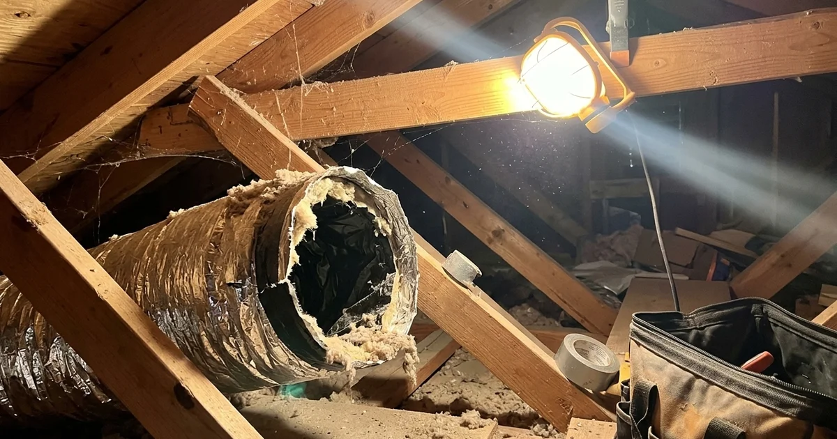 A disconnected duct joint leaking air in a hot attic